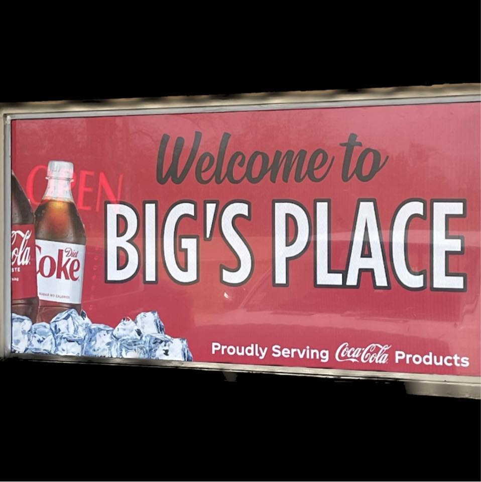 The 'Welcome to Big's Place' sign at the country store