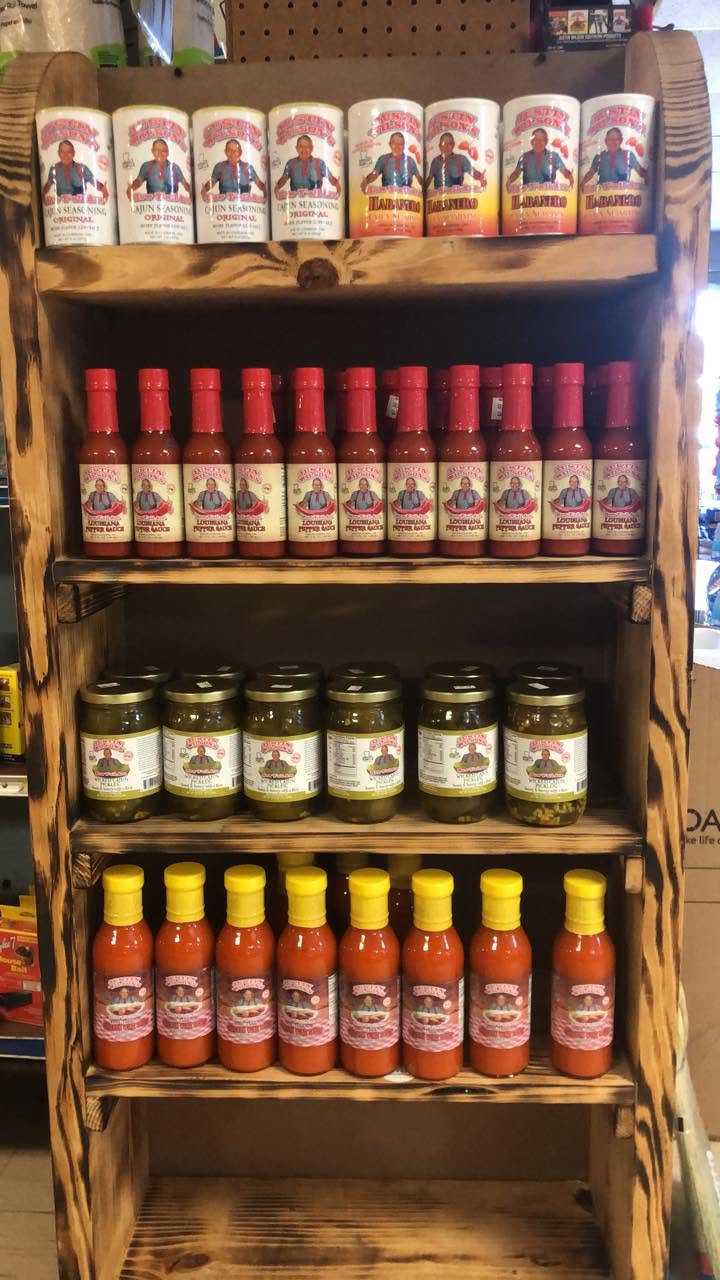 Wooden shelves of local sauces and jarred goods