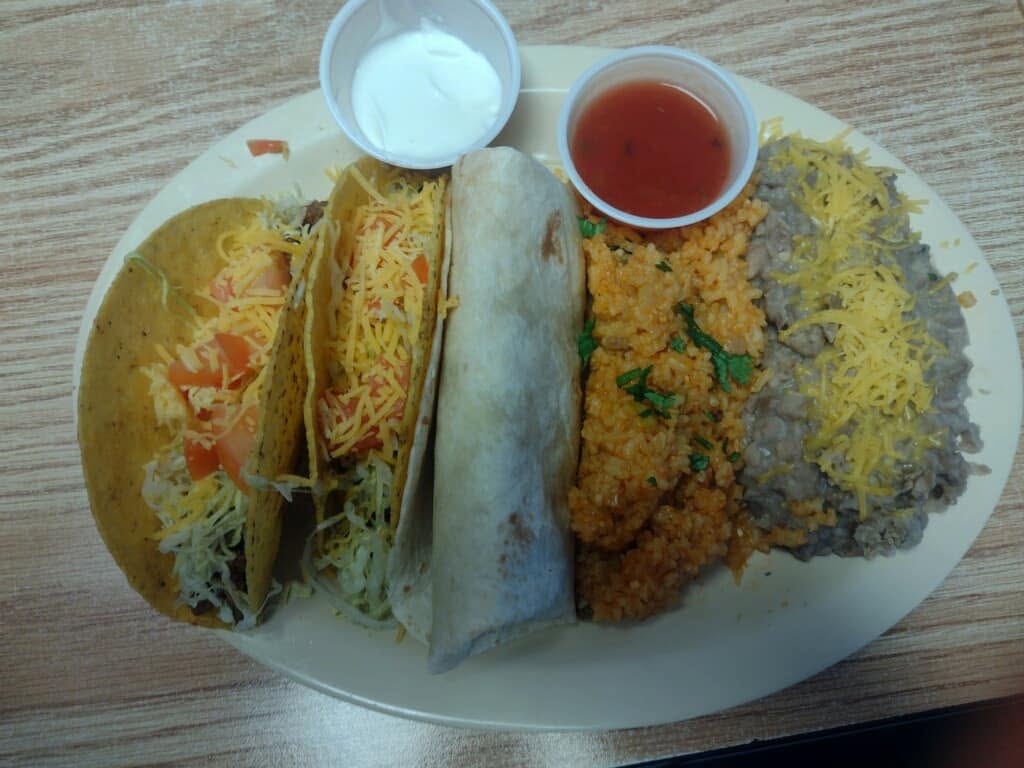 Taco plate with burrito, rice and refried beans