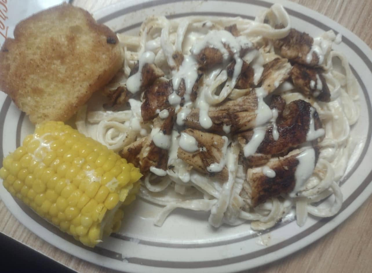 Chicken alfredo pasta with cornbread and corn on the cob