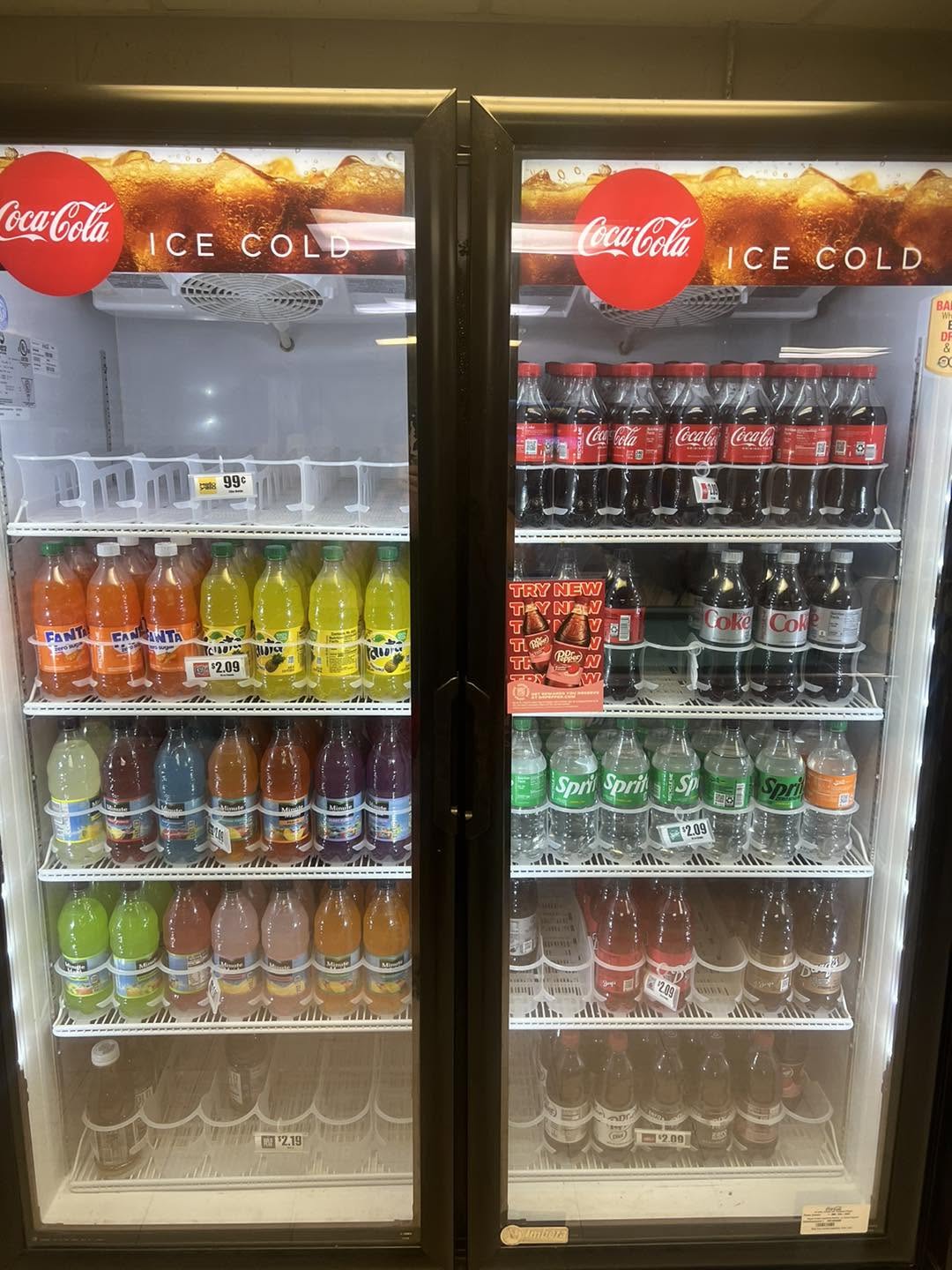 Refrigerated coolers stocked with ice-cold Coca-Cola, Sprite, Fanta and sports drinks
